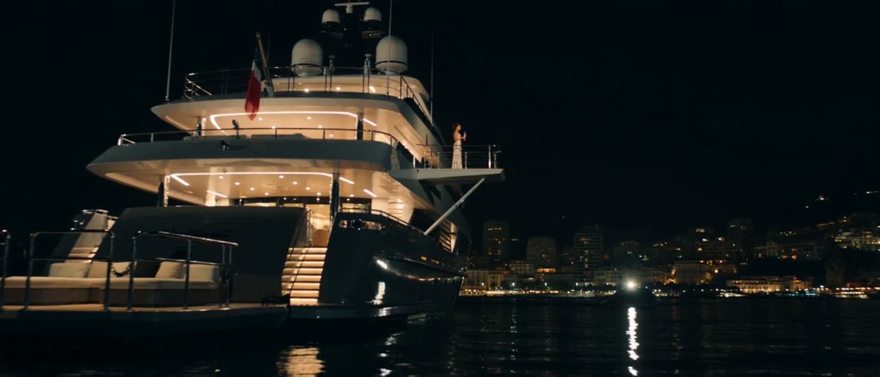 A superyacht lit at anchor off Monaco at night
